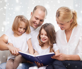 Image showing happy family with book at home