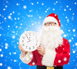 Image showing man in costume of santa claus with clock