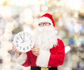 Image showing man in costume of santa claus with clock