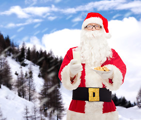 Image showing santa claus with glass of milk and cookies