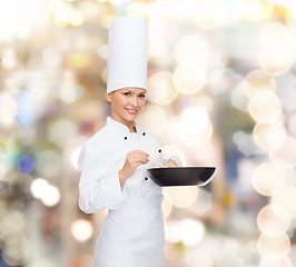 Image showing smiling female chef with pan and spoon