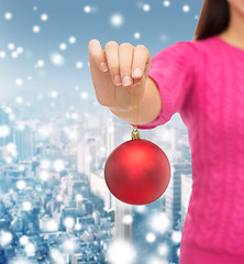 Image showing close up of woman in sweater with christmas ball