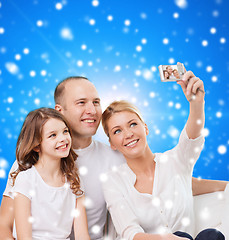 Image showing happy family with camera at home