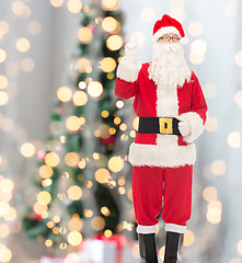 Image showing man in costume of santa claus pointing finger up