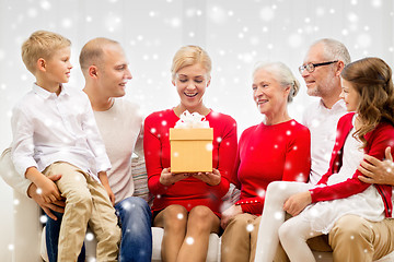 Image showing smiling family with gifts at home