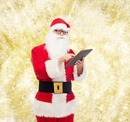 Image showing man in costume of santa claus with tablet pc