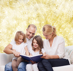 Image showing happy family with book at home