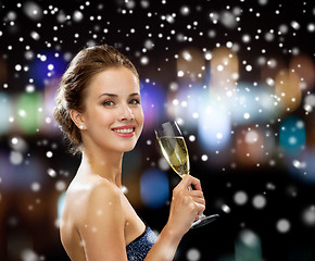 Image showing smiling woman holding glass of sparkling wine