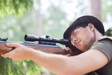 Image showing young soldier or hunter with gun in forest