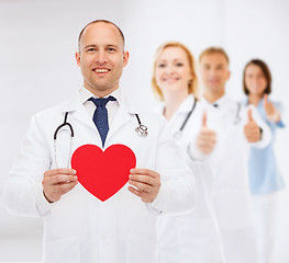 Image showing smiling male doctor with red heart and stethoscope