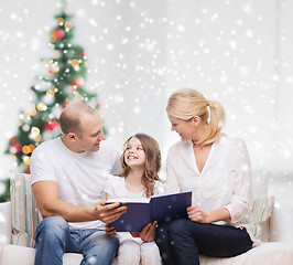 Image showing happy family with book at home