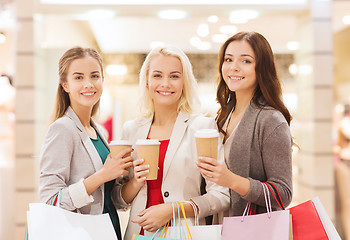 Image showing young women with shopping bags and coffee in mall