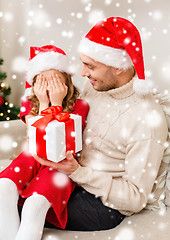 Image showing smiling father and daughter holding gift box