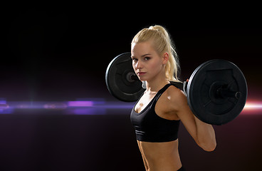 Image showing sporty woman exercising with barbell