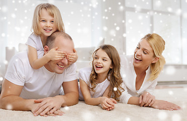 Image showing smiling parents and two little girls at home