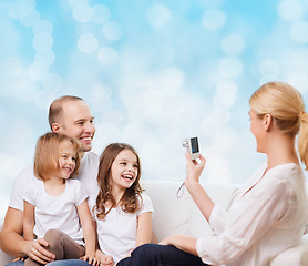 Image showing happy family with camera at home