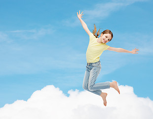 Image showing smiling little girl jumping