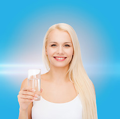 Image showing young smiling woman with glass of water