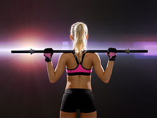 Image showing sporty woman exercising with barbell