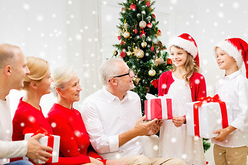 Image showing smiling family with gifts at home