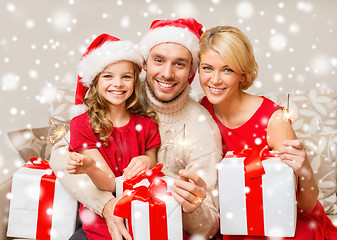 Image showing happy family with gifts and sparklers