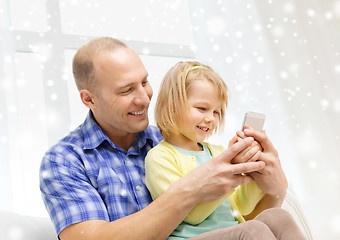 Image showing happy father and daughter with smartphone