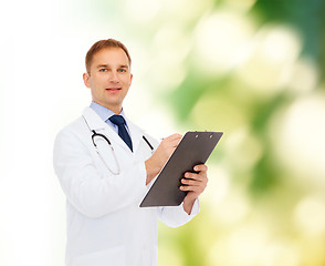 Image showing smiling male doctor with clipboard and stethoscope