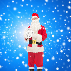 Image showing man in costume of santa claus with clock