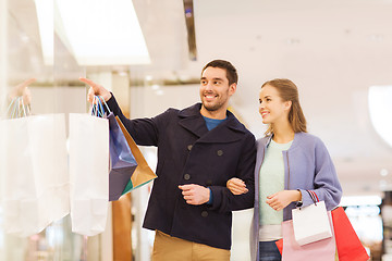 Image showing happy young couple with shopping bags in mall