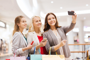 Image showing women with smartphones shopping and taking selfie