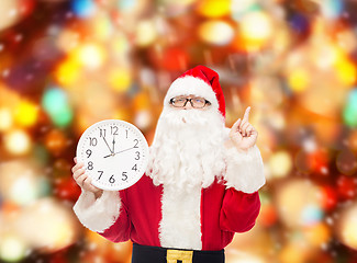 Image showing man in costume of santa claus with clock