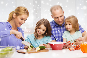 Image showing happy family with two kids making dinner at home