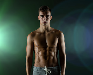 Image showing young male bodybuilder with bare muscular torso