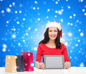 Image showing smiling woman with shopping bags and tablet pc