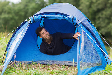 Image showing smiling male tourist with beard in tent