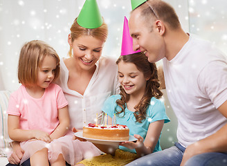 Image showing happy family with two kids in party hats at home