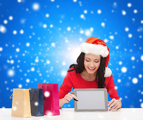 Image showing smiling woman with shopping bags and tablet pc