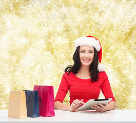 Image showing smiling woman with shopping bags and tablet pc