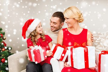 Image showing smiling family holding many gift boxes