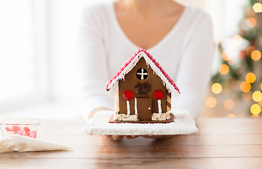 Image showing close up of woman showing gingerbread house