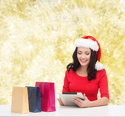 Image showing smiling woman with shopping bags and tablet pc