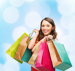 Image showing smiling woman with colorful shopping bags