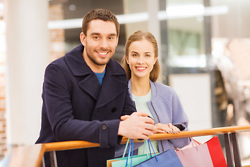 Image showing happy young couple with shopping bags in mall