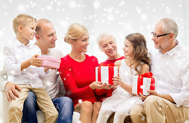 Image showing smiling family with gifts at home