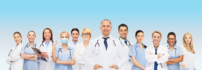 Image showing group of smiling doctors with clipboard