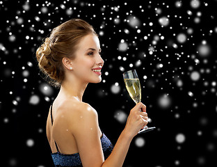 Image showing smiling woman holding glass of sparkling wine