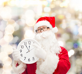 Image showing man in costume of santa claus with clock