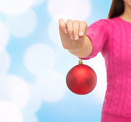 Image showing close up of woman in sweater with christmas ball