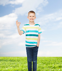Image showing little boy in casual clothes making OK gesture