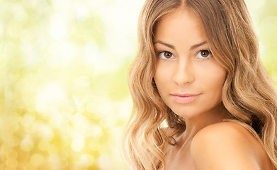 Image showing beautiful young woman over yellow background